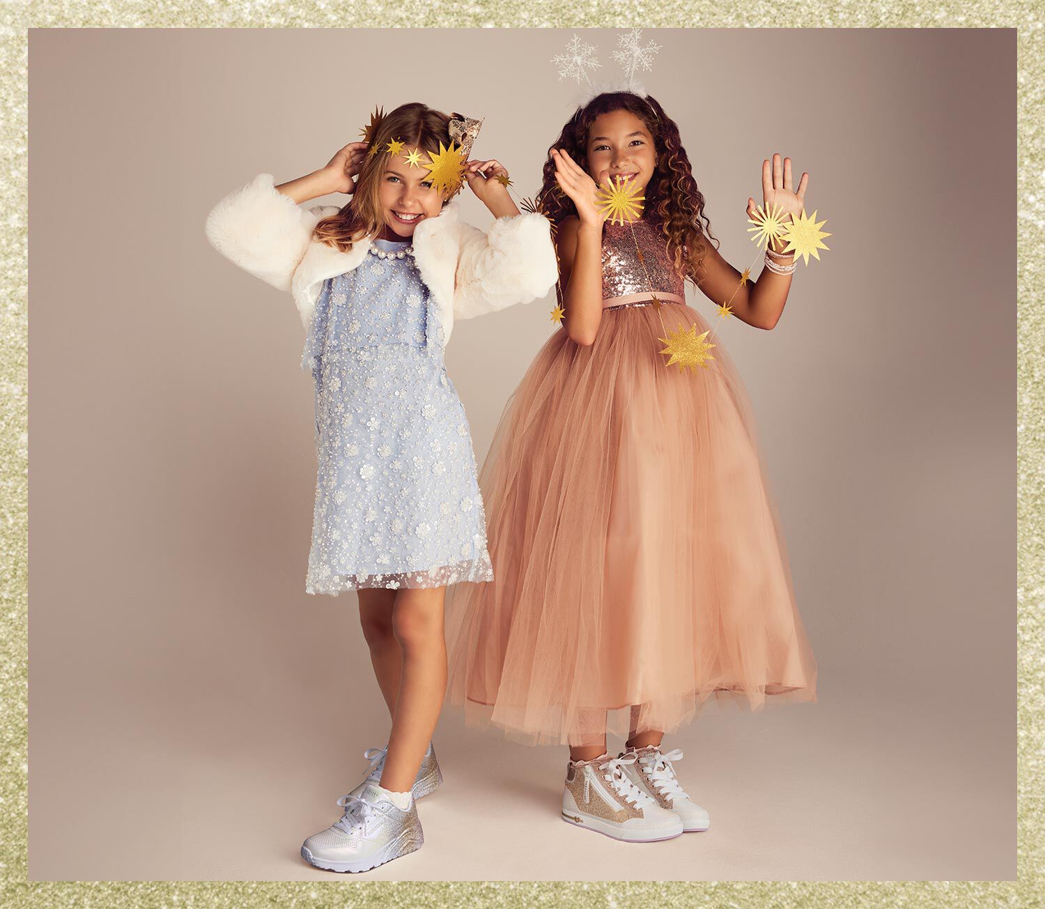 Two girls sitting on blankets with Skechers boots